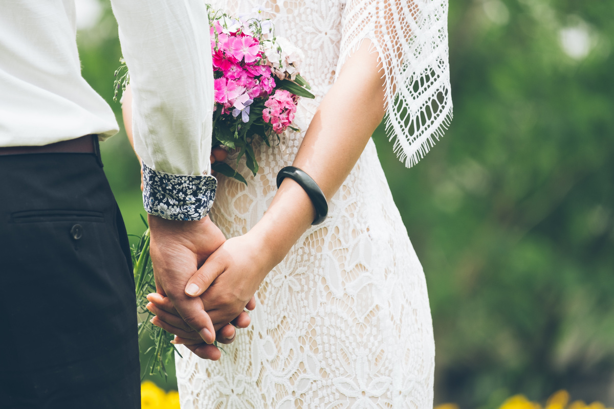 Bride and Groom Holding Hands Outdoors